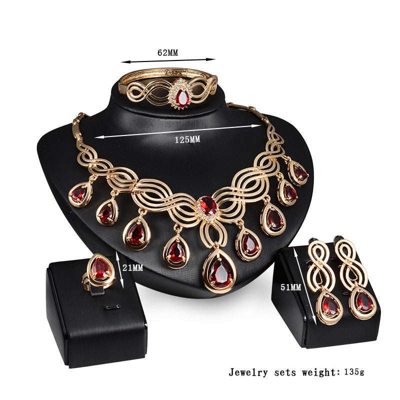A Maramalive™ gold jewelry set with red stones.