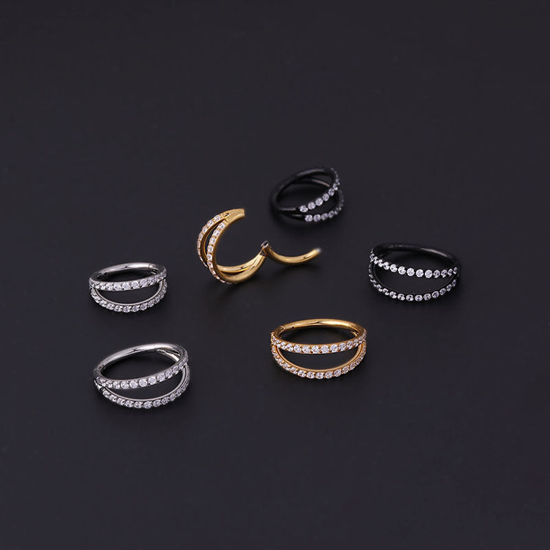 A set of Maramalive™ Stainless Steel Double Row Carved Zircon Seamless Nose Rings on a black surface.