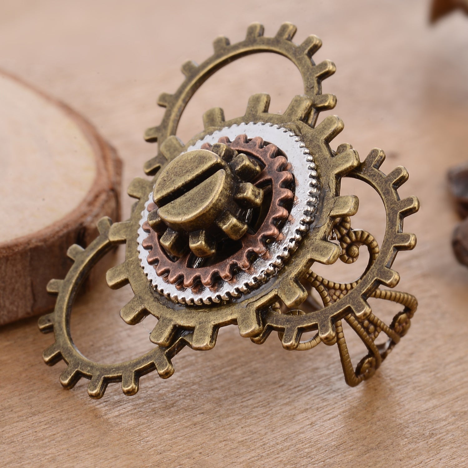 A woman's hand with a Maramalive™ Retro Steampunk 3 Ring Gear Ornament on it.