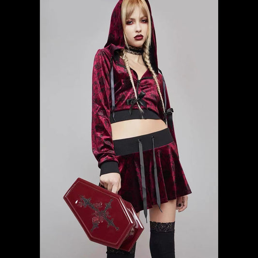 A girl in a burgundy velvet skirt and hoodie with a zipper was carrying the Maramalive™ Red Punk Gothic Patent Leather Embroidered Coffin Bag.