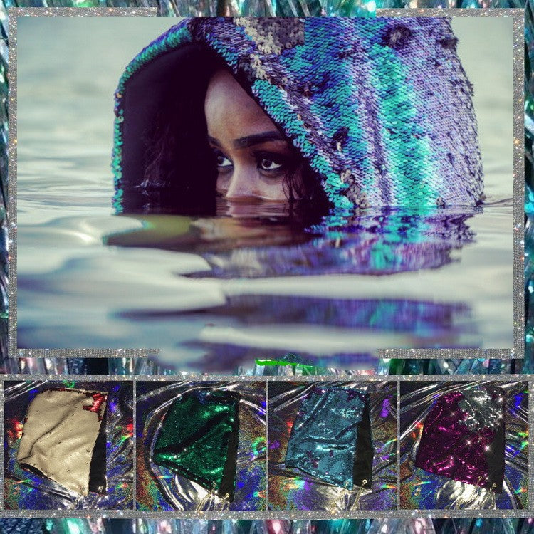 A woman wearing a Mermaid Phantom Glitter Dark Gothic Big Hat Bungee Dee Hood from Maramalive™ in the water.