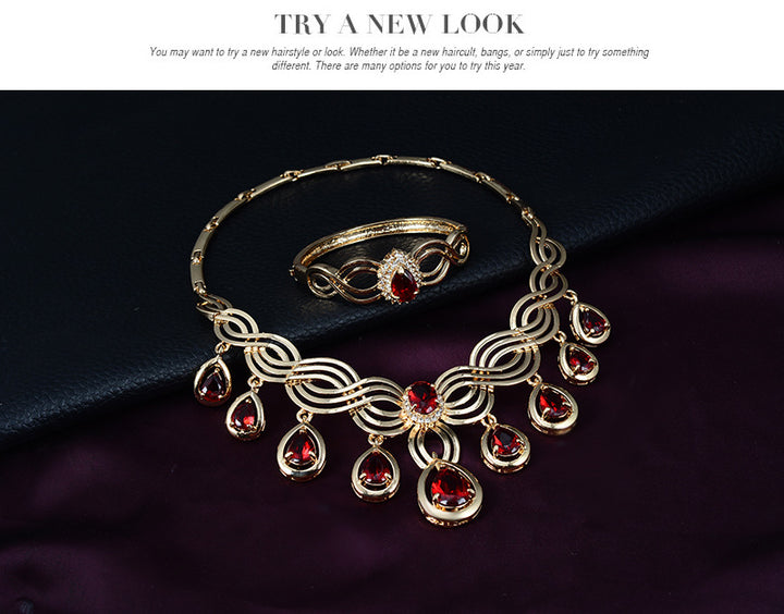 A Maramalive™ gold jewelry set with red stones.