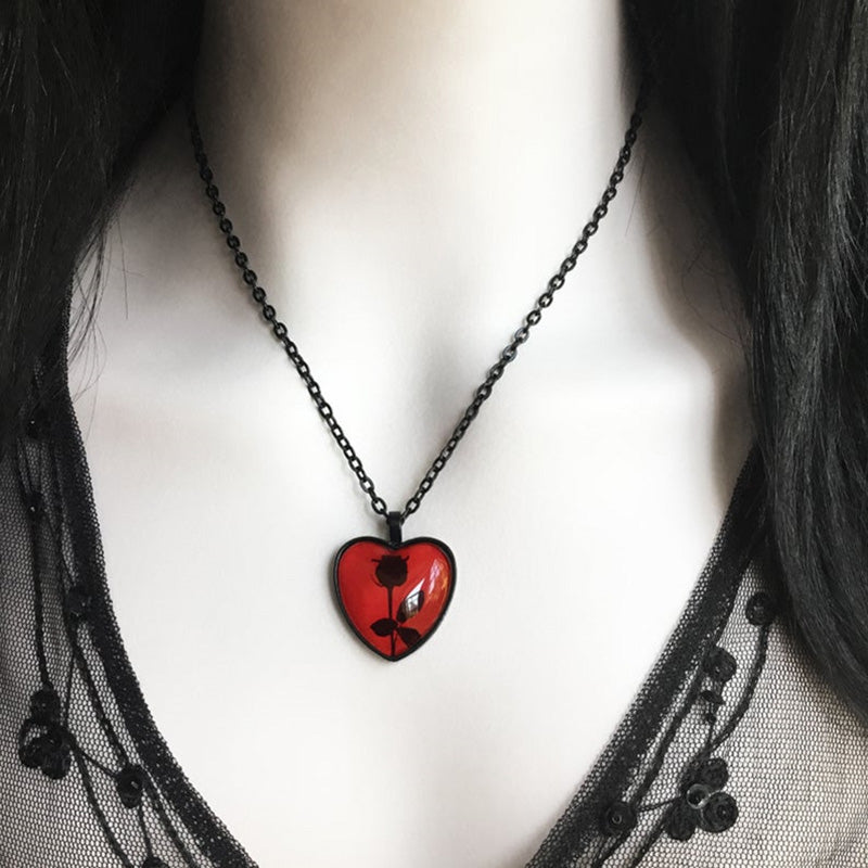 A vintage Heart of Darkness Necklace Gothic Black Rose Flower Heart Pendant Necklace with a gothic rose on it by Maramalive™.
