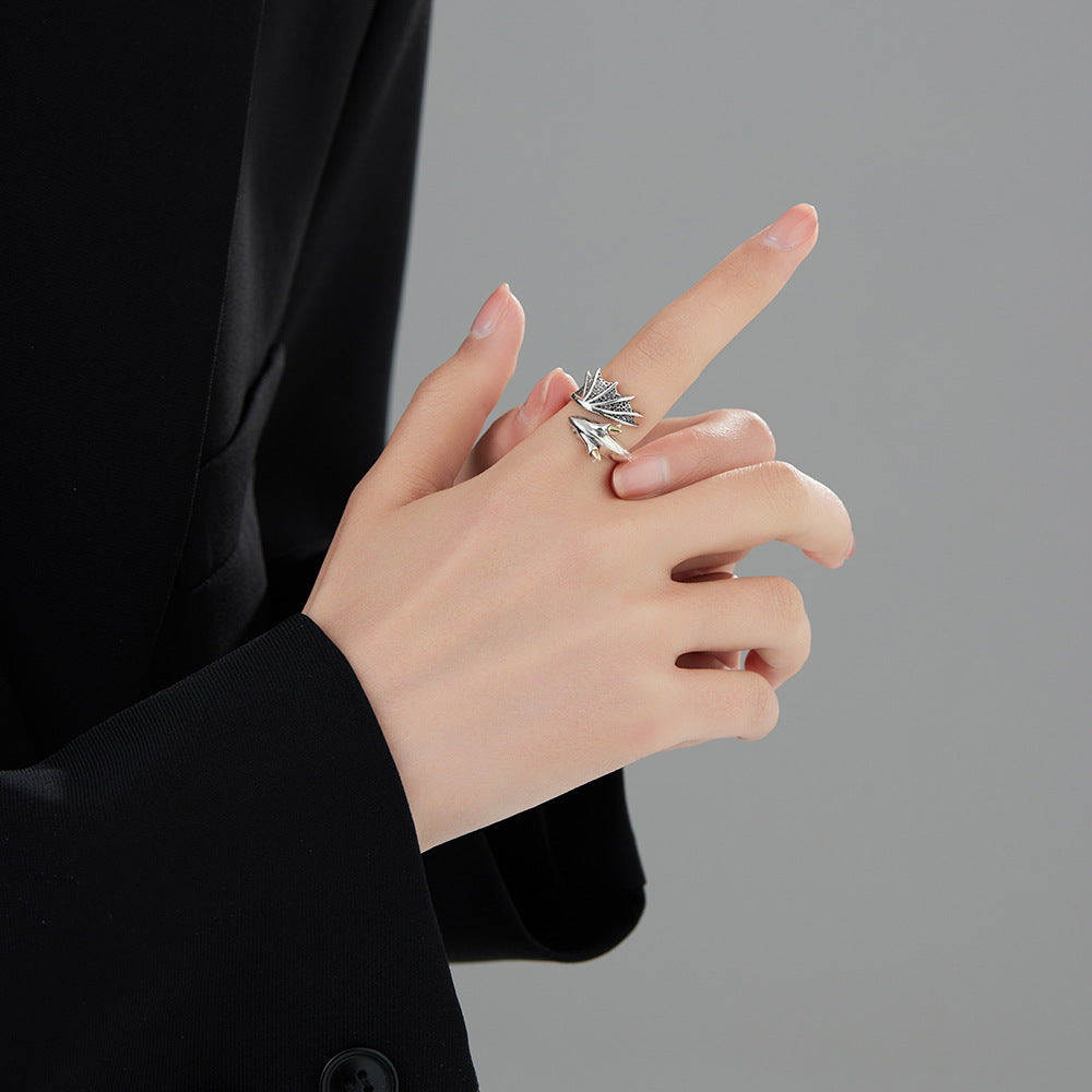 A woman wearing a black suit and a Maramalive™ S925 Sterling Silver Flying Dragon Ring Retro Minority.