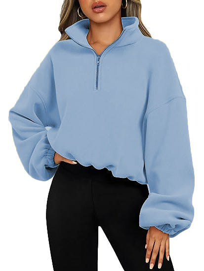 A fashionable and simple look: a woman wearing a Maramalive™ Loose Sport Pullover Hoodie Women Winter Solid Color Zipper Stand Collar Sweatshirt Thick Warm Clothing in light blue. She is also wearing black leggings.
