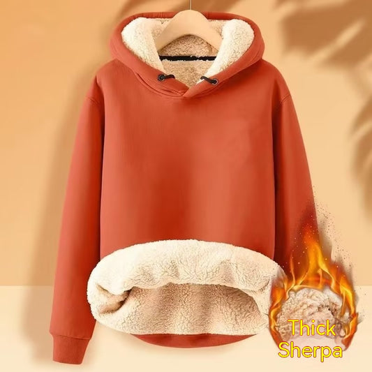 An orange Men's Fleece Hoodie Winter Lined Padded Warm Keeping Loose Hooded Sweater from Maramalive™ with a thick sherpa lining hanging on a hanger. The sweatshirt has a design that makes it appear to be on fire, with the words "Thick Sherpa" accompanying the image.