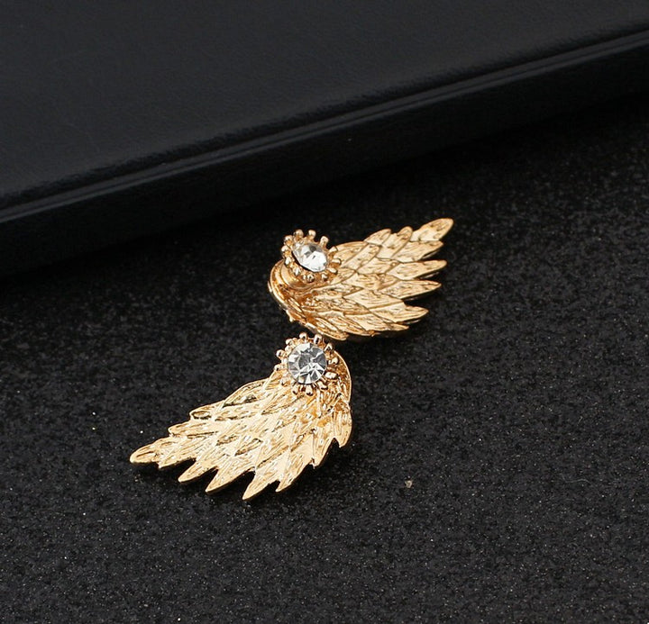 A woman wearing a stunning pair of Maramalive™ Angel Wings Women Earrings Inlaid Crystal Ear Jewelry Earring Party Gothic Feather Earrings Fashion Bijoux Gold Color.