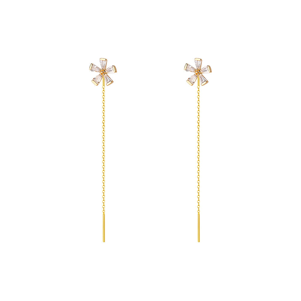 A woman wearing a pair of Maramalive™ Women's Graceful And Fashionable Sterling Silver Zircon Flower Earrings with a star in the middle.