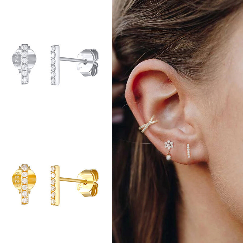 A woman's ear with a Maramalive™ S925 Sterling Silver Single Row Ball Stud Earrings White Gold Color.