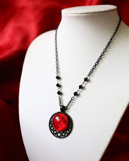 A mannequin is wearing a Moon Gothic Necklace with a moon on it by Maramalive™.