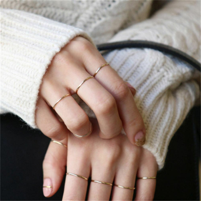 A woman's hands with several Stylish Glossy Fine Circle Couple Simple Simple Bracelet Rings from Maramalive™.