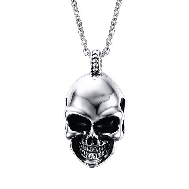 A Titanium Steel Cool Skull Necklace from Maramalive™ on a black background with a chain necklace.