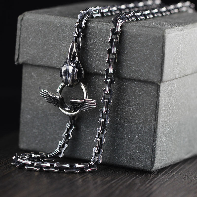 A Maramalive™ silver chain with a Silver Cross Pendant on it.