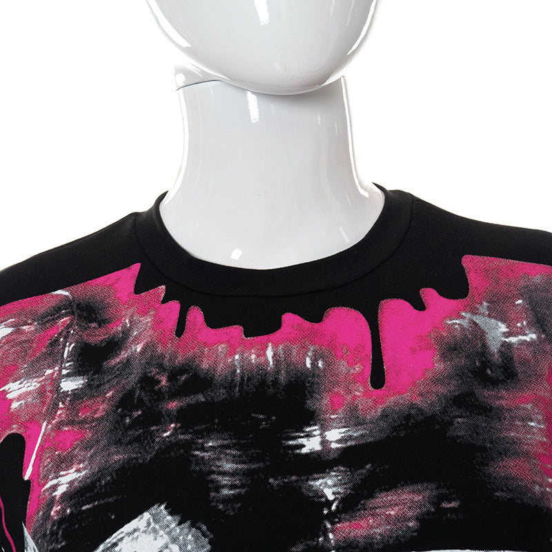 Mannequin wearing a Maramalive™ Chic Oversized Short Sleeve Tees for Women with a black base, featuring a pink and white abstract paint splatter design on the chest. This casual t-shirt offers both style and comfort.