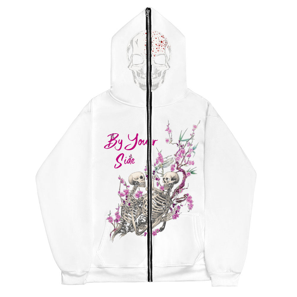 A Gothic Couple Harajuku Black Sweatshirt Zipper Sweater by Maramalive™ with a design showing two intertwined skeletons surrounded by pink blossoms and the phrase "By Your Side" in pink text.