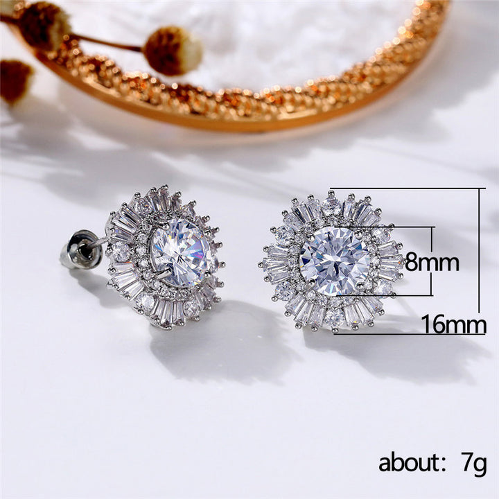 A woman's hand holding a pair of Maramalive™ New High-end Luxury Full Rhinestone Zircon Snowflake Earrings.