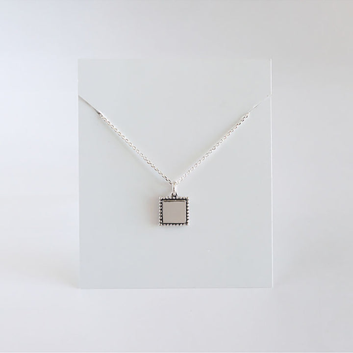 A small Retro Minimalist Necklace by Maramalive™ on a white surface.