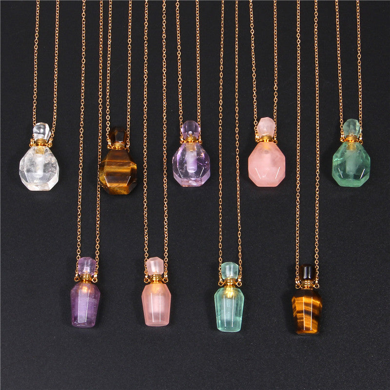 A group of different colored Maramalive™ Refillable Crystal Perfume Pendants on a gold chain.