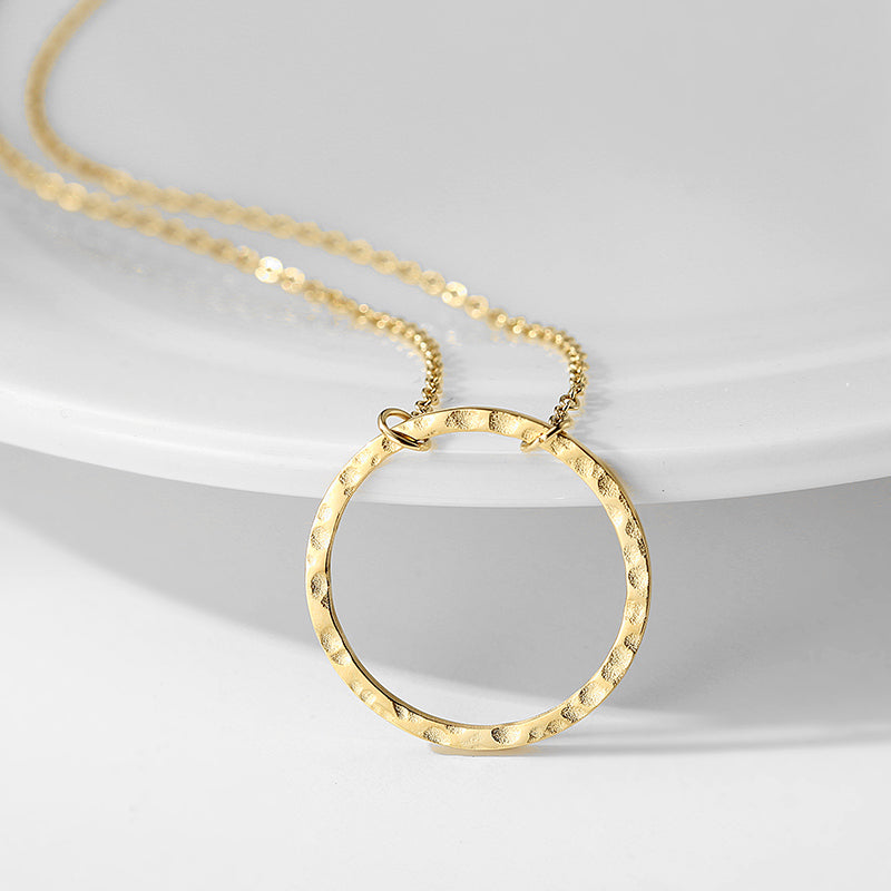 A Gold-plated Minimalist Pendant Jewelry by Maramalive™ on a white plate.