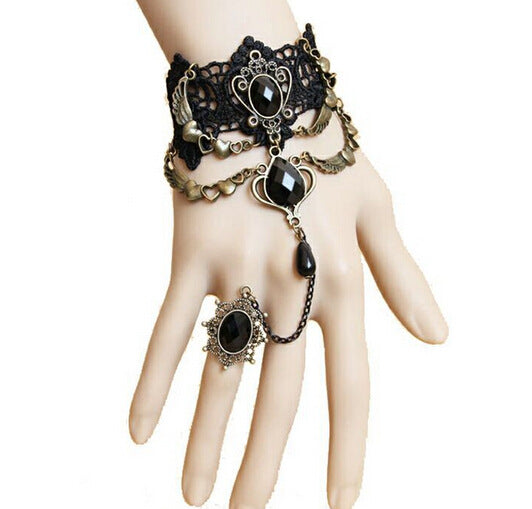 A mannequin's hand adorned with a Vintage Black Lace Bracelet and Ring from Maramalive™ exudes a touch of Gothic glamour.