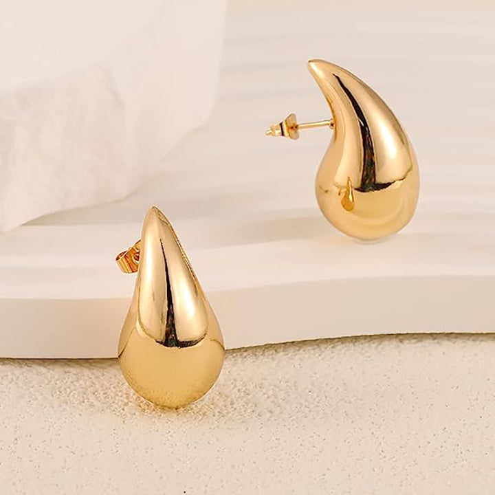 A pair of Maramalive™ Water Drop Earrings on a white cloth.