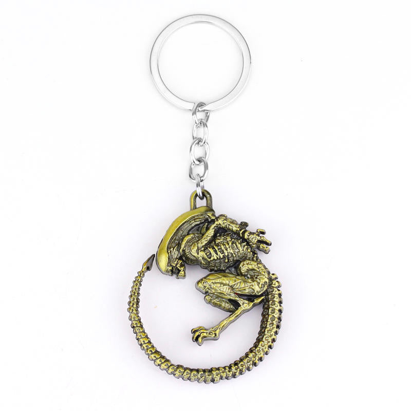 Two Simple And Creative Alien Battle Keychains with a skeleton on them, by Maramalive™.