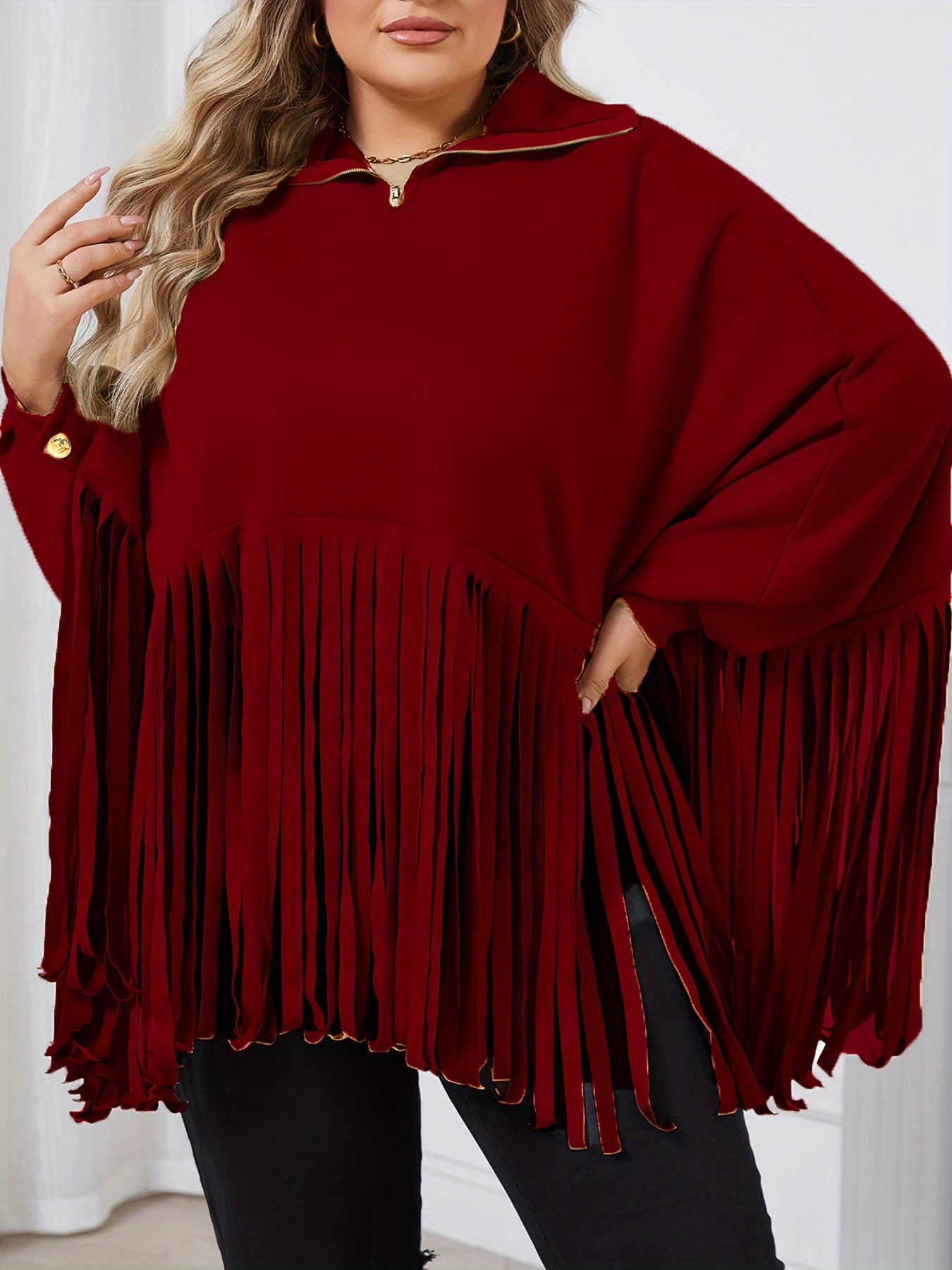 Person wearing a Maramalive™ Women's Plus Solid Batwing Sleeve Mock Neck Fringe Trim Cloak Top, standing indoors against a white background. Perfect for the Fall/Winter season.