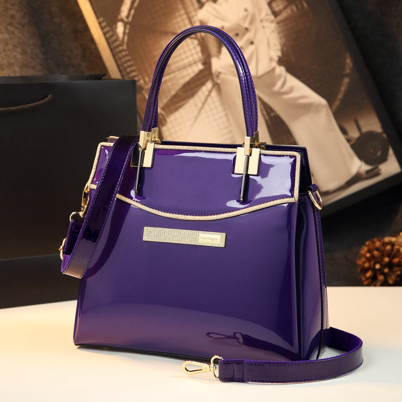 A purple patent leather shoulder messenger bag with gold hardware, brand name Maramalive™.
