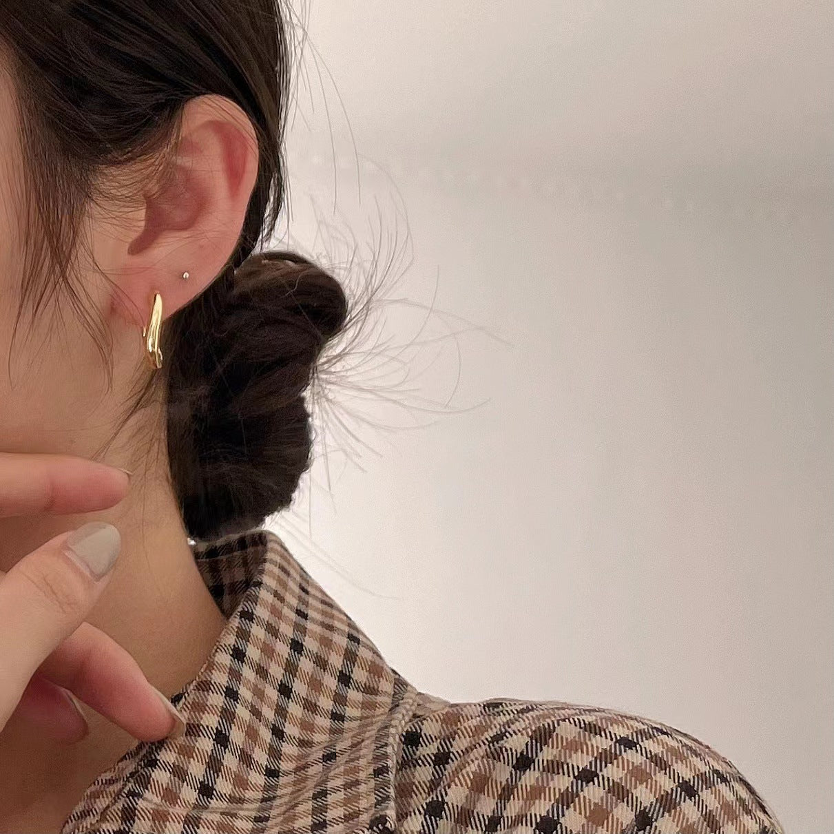 A woman wearing a plaid shirt and a pair of Maramalive™ Sterling Silver Earrings.