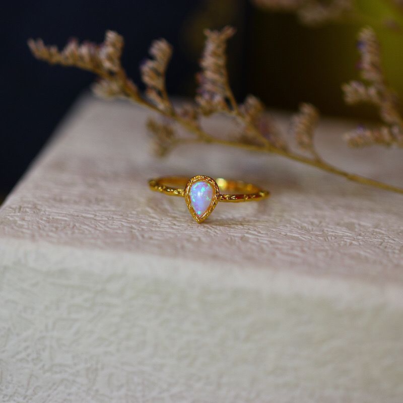 A Women's Fashion Vintage Opal Ring from Maramalive™ sitting on top of a box.