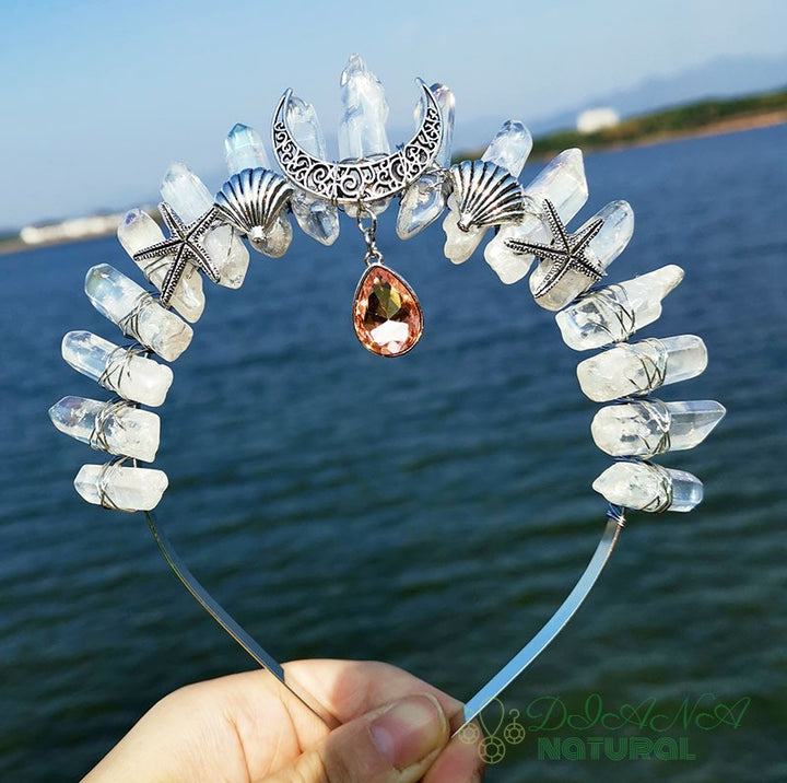 A person is holding a Multicolored Starfish Moon Pendant headband with Maramalive™ star, moon and seashells.