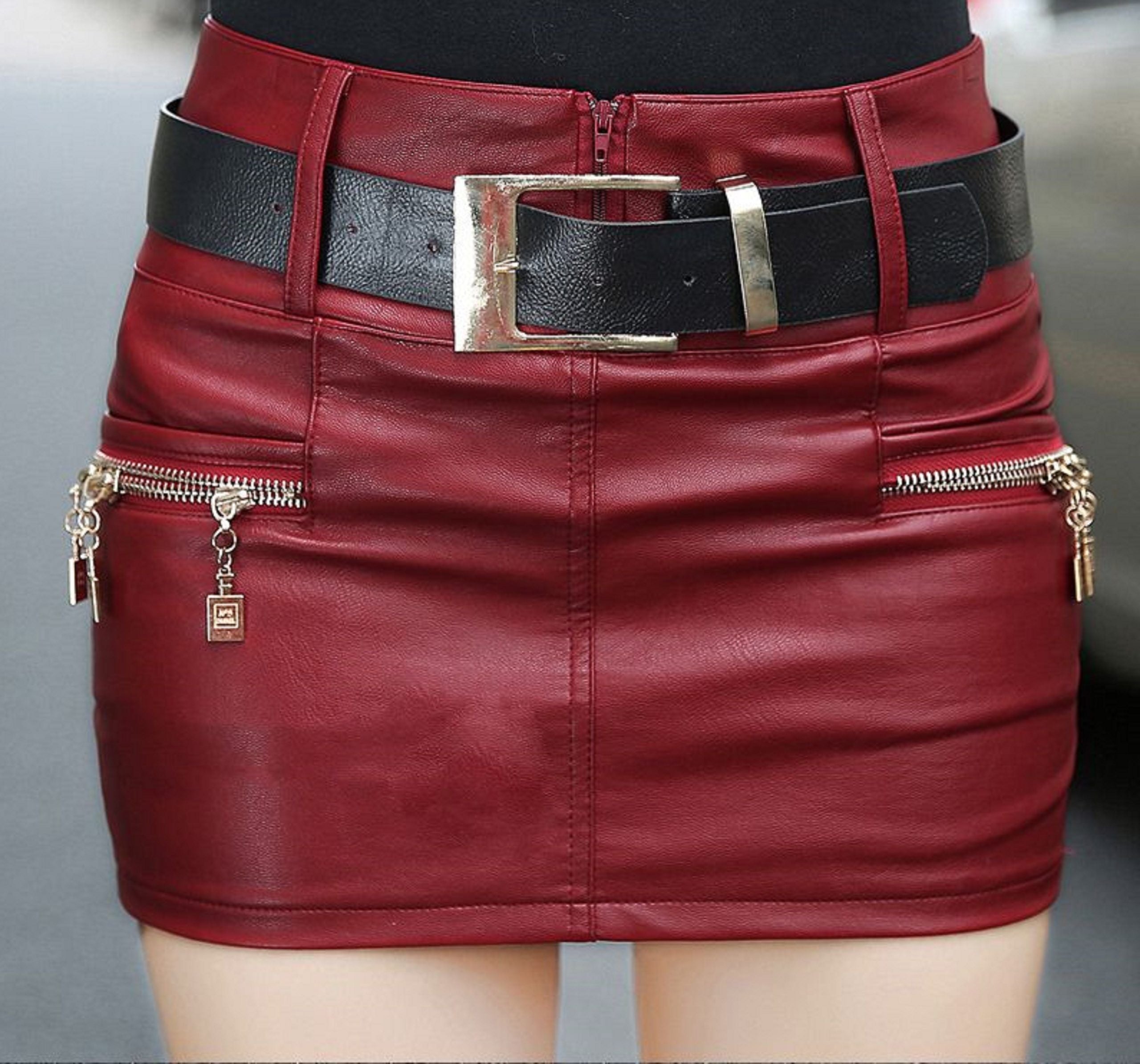 A woman in a red Maramalive™ Faux Leather Mini Skirt - Vegan-Friendly Leather Belt Skirt
