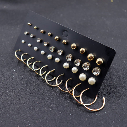 A set of Maramalive™ Pearl Circle Stud Earrings with pearls on a black background.