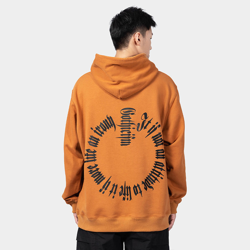 A person with short black hair is wearing a Maramalive™ European Hip Hop Gothic Sweater Men's Hoodie with black, circular text on the back, standing against a plain light gray background.