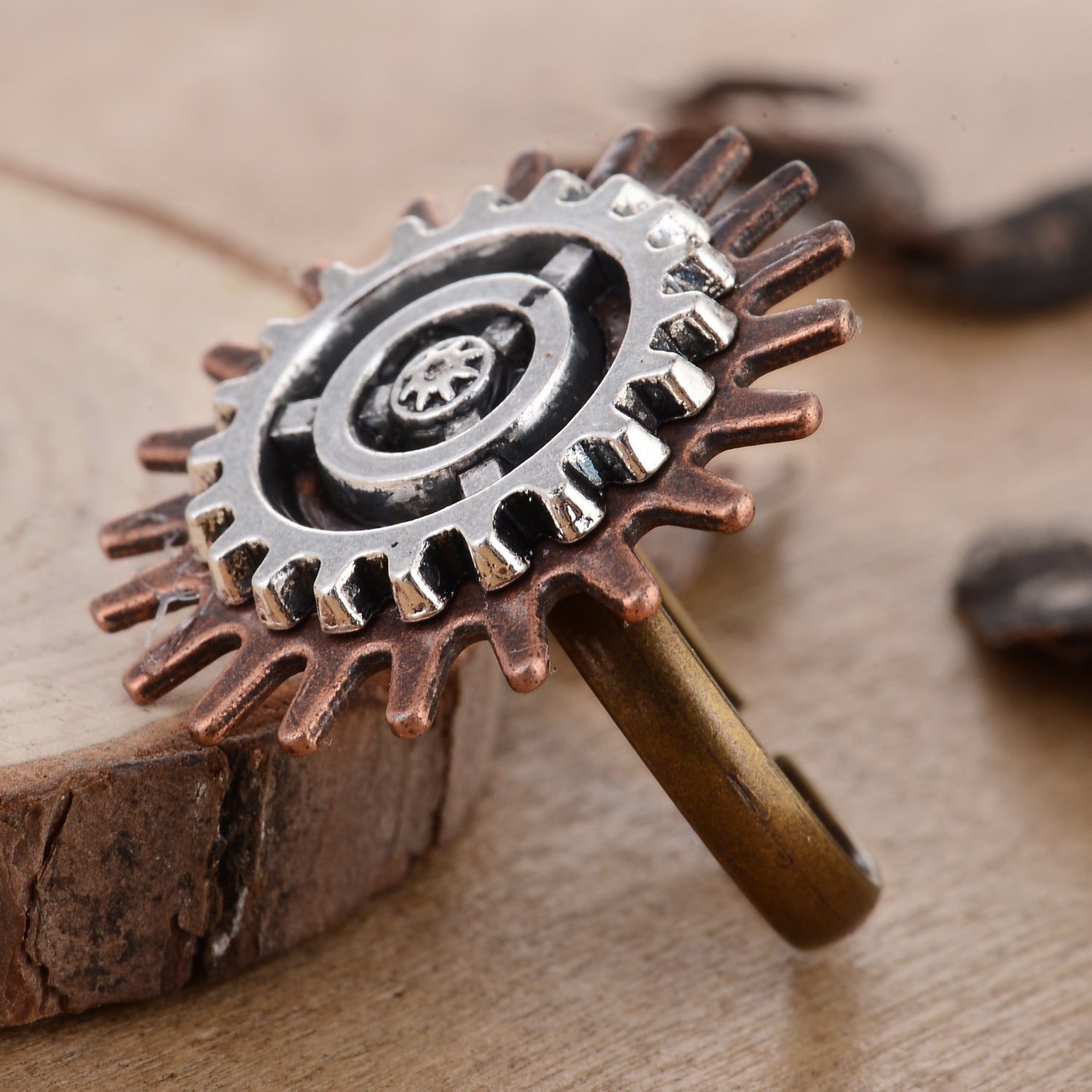 A woman's hand with a Retro Steampunk 3 Ring Gear Ring Jewelry by Maramalive™ on it.