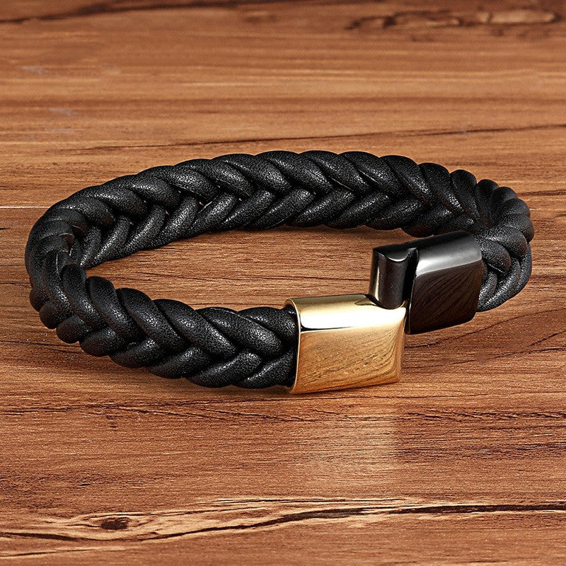 A man wearing a Maramalive™ Stainless Steel Titanium Two-tone Buckle Leather Cord Bracelet with a gold clasp.