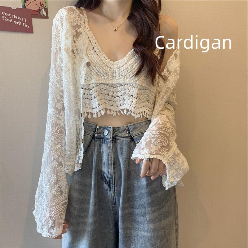 A woman is donning a white lace cardigan, adorned with delicate crocheted flowers, over a matching lace crop top and high-waisted jeans. The words "Crocheted Two-piece Set Female Summer New Western Style Blouse Top" from Maramalive™ grace the image, capturing the fresh and sweet style of her ensemble.