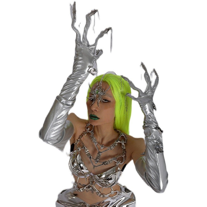 Person with neon green hair wearing a Maramalive™ Punk Futuristic Silver Metallic Performance Suit and electroplated jewelry, including an elaborate neck chain jewelry, striking a dramatic pose with hands raised.