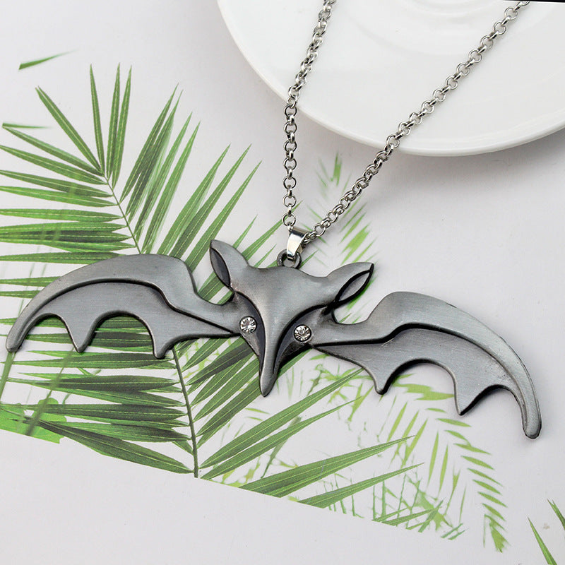 A Maramalive™ Halloween Animal Bat Wing Diamond Necklace is sitting on top of a wooden box.