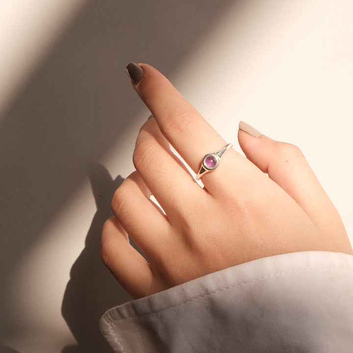 A woman wearing a Maramalive™ European And American All-match Pearl Black Onyx Ring with an evil eye on it.