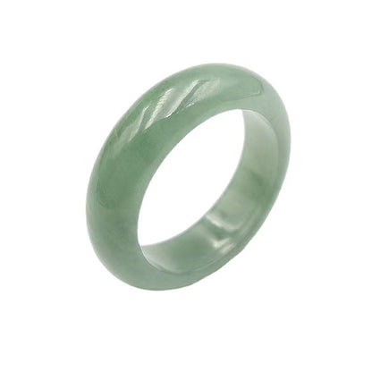 A Natural Jade Ring by Maramalive™ sitting on a wooden table.