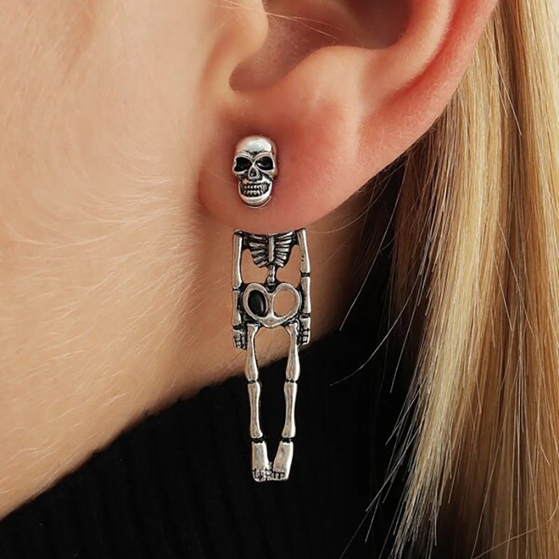 A woman wearing a pair of Maramalive™ Halloween Skull Simulation Human Skeleton Detachable Stud Earrings.