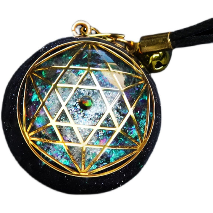 A Maramalive™ black and gold pendant with a Geometric Totem Om Yoga Crystal Necklace on it.