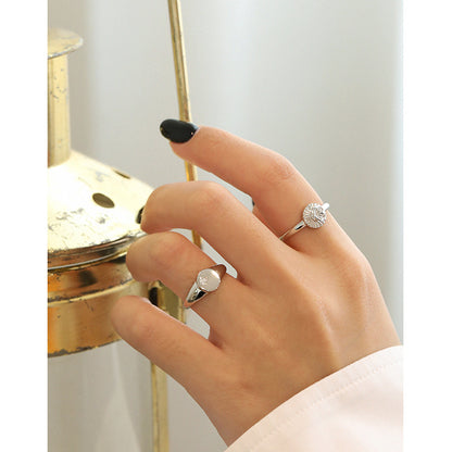 A woman's hand is holding a Micro-Set Zircon Sterling Silver Ring from Maramalive™.
