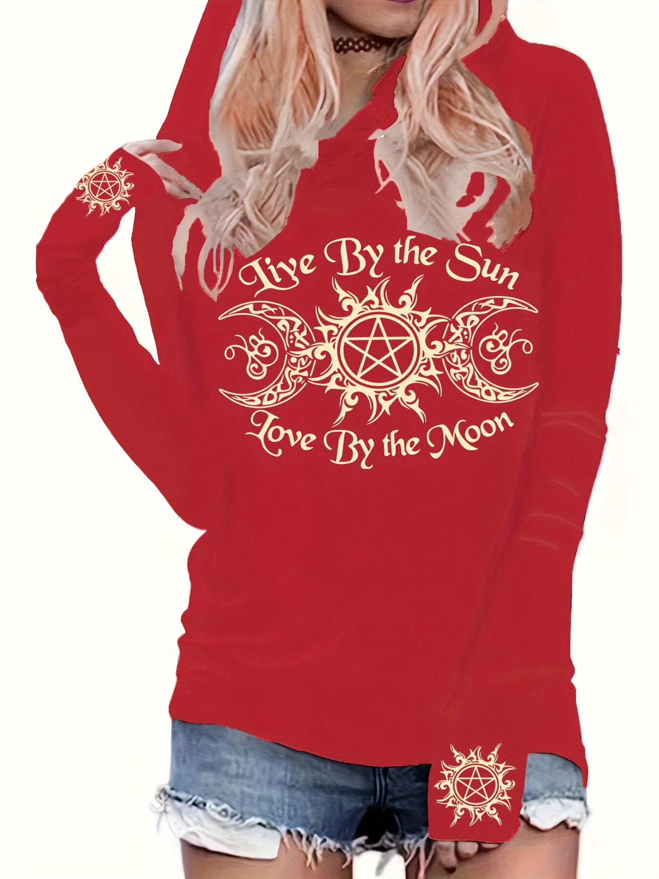 A person wearing a red Maramalive™ Gothic Graphic Print Hooded T-shirt with a design that reads "Live By the Sun, Love By the Moon" and a decorative design on it. The hooded T-shirt is paired with denim shorts, offering a casual fit perfect for everyday wear. It's also machine washable for easy care.