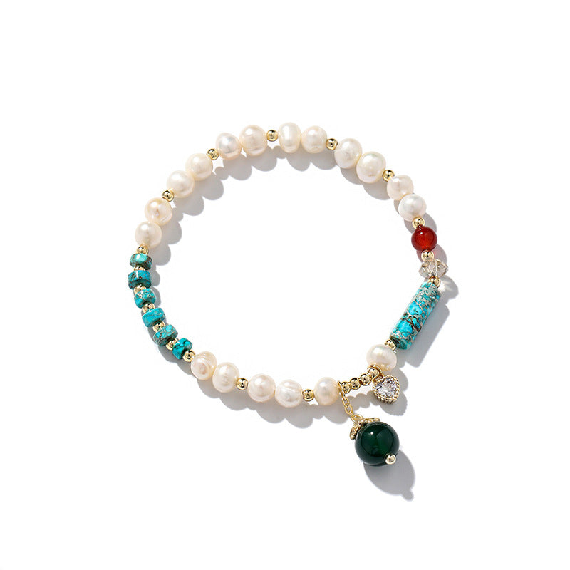 A woman wearing a Maramalive™ Natural Freshwater Pearl Color Matching Agate Turquoise Bracelet.
