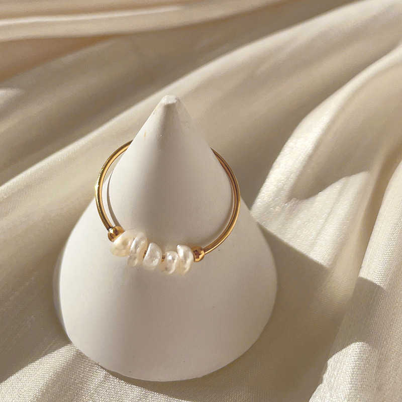 A Sweet French Natural Baroque Small Pearl Thin Titanium Steel Ring with pearls on top of a plate by Maramalive™.