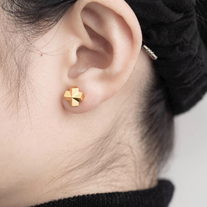 A woman's ear with a pair of Maramalive™ Geometric Earrings for Women.