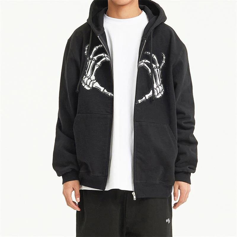 Person wearing a black Maramalive™ Comfy Zipper Hoodies for Fall: Hooded Sweatshirts & Sweaters with a skeleton hand design on the chest over a white T-shirt, and black pants. The hoodie is unzipped. The face is not visible, making this outfit an ideal autumn companion for those who appreciate versatile style.