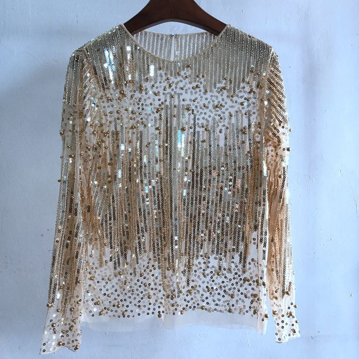 Maramalive™ Fashion Bottoming Shirt Sequined Top For Women with long sleeves, featuring gold sequins arranged in a fringe pattern. Crafted from lightweight polyester fiber, this free size piece offers both elegance and comfort.